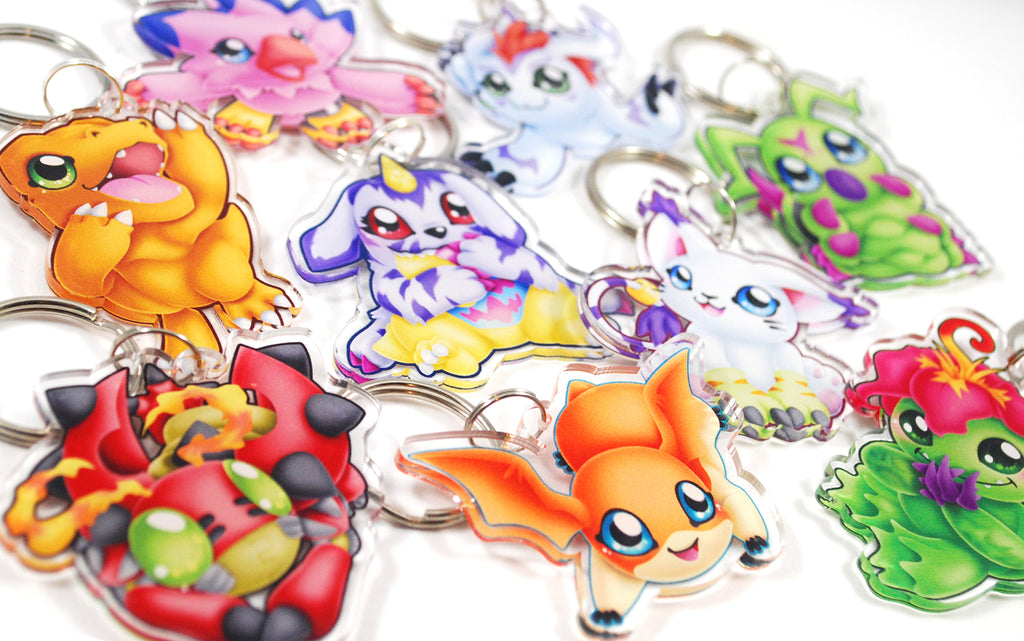 Collection of colorful cartoon-like keychains on a white background