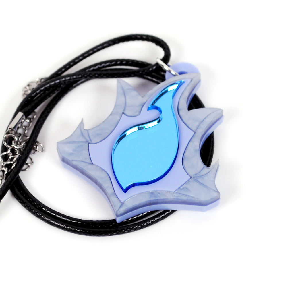 A light blue and lavender flame-shaped pendant necklace with a glossy blue center, attached to a black braided cord and silver-toned chain links, shown on a white background.