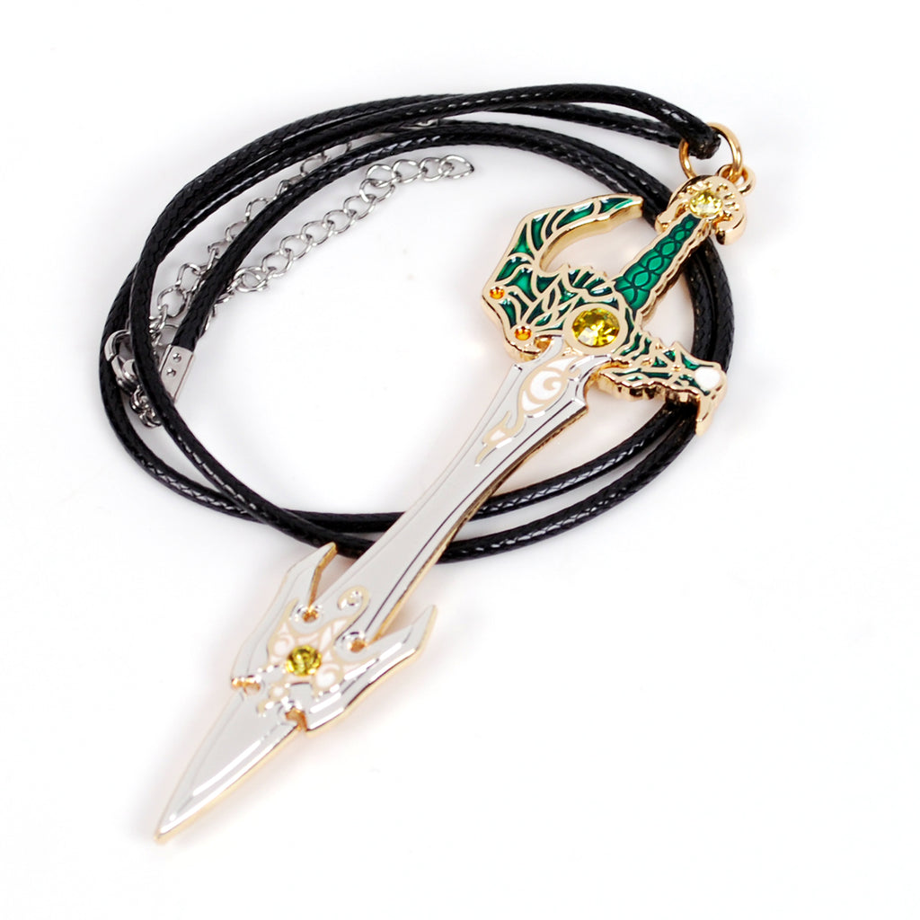 A fantasy sword pendant necklace on a black multi-strand cord. The pendant features a silver-colored blade with gold trim, a green and gold hilt, and small yellow gem accents, displayed on a clean white background.