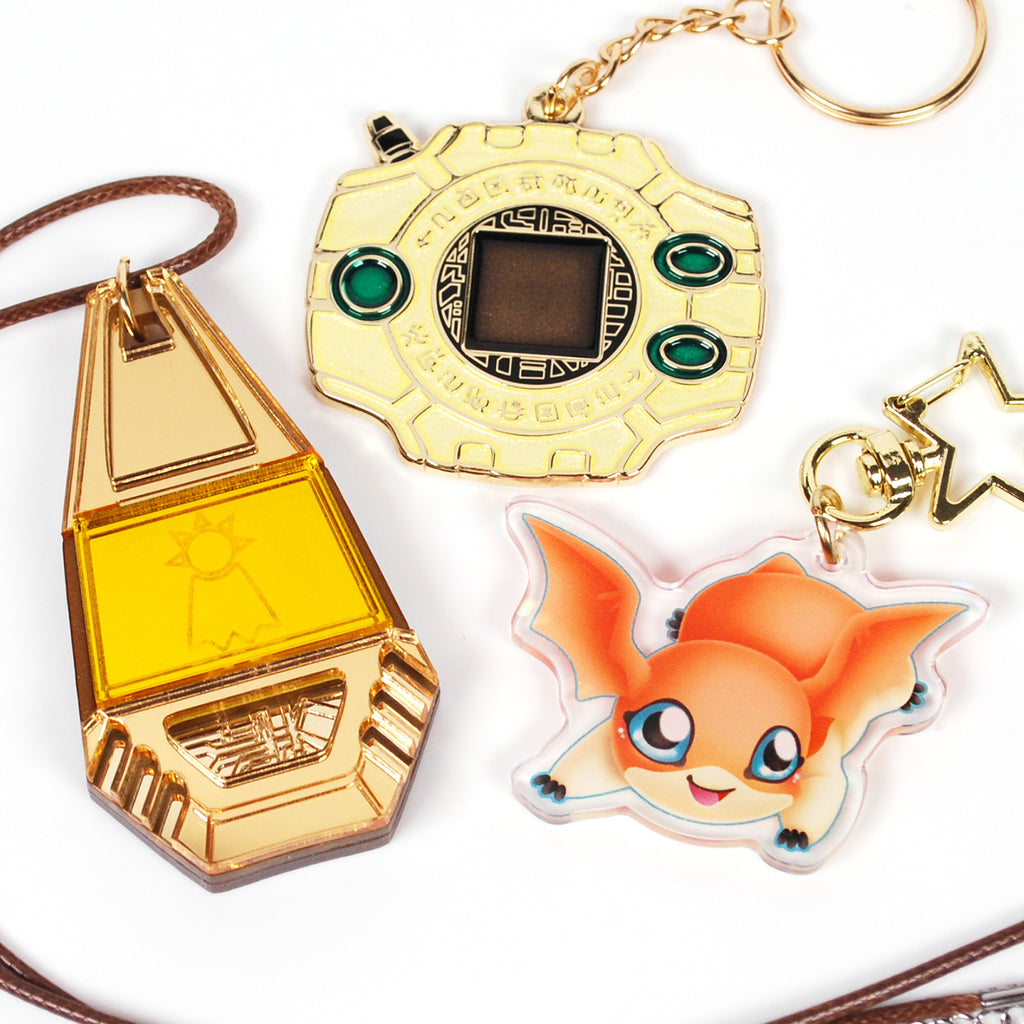 Three keychain charms on a white background.