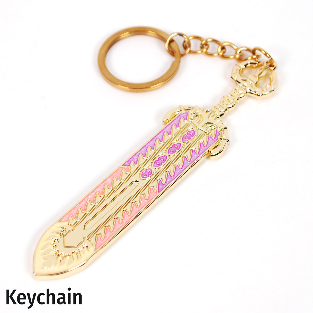 A gold-colored pendant shaped like a decorative sword, shown on a gold chain keychain. The pendant has engraved patterns with pink, orange, and yellow pearlescent enamels. It is photographed on a white background. It reads "keychain" in the bottom left hand corner.
